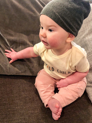 Baby wearing Wild Child onesie.